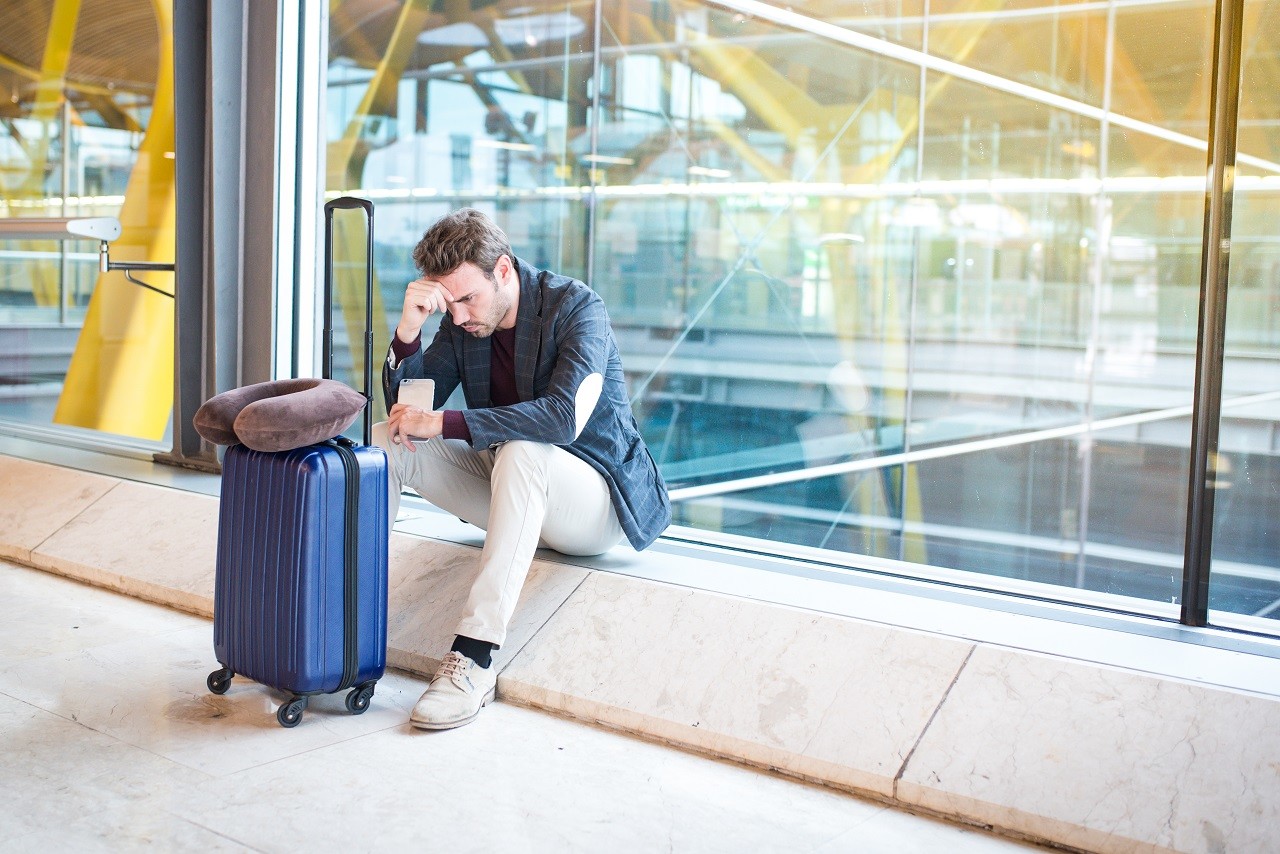 Man upset at the airport his flight is delayed